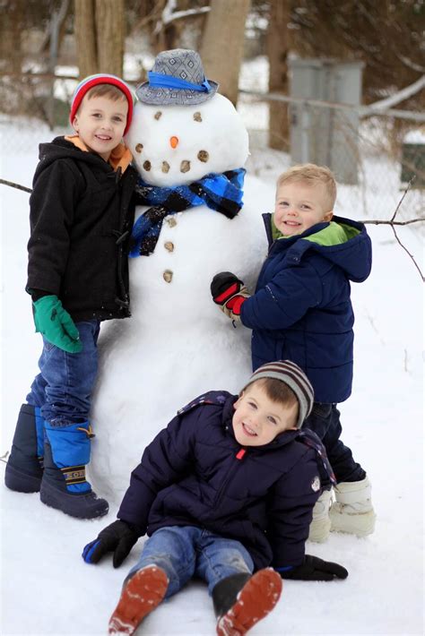 kids posing with snowman - Raising Roberts