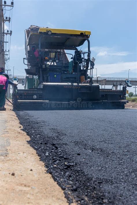 Paver Machine On A New Asphalt Road Surface Laying Of A New Asphalt