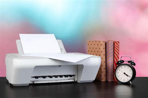 Premium Photo | Compact home printer on desk with books against blurred ...