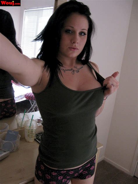 Tattooed Brunette Babe Taking Pictures Of Her Big Cleavage Photos