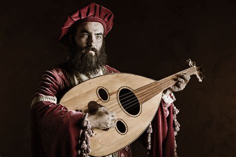 A Man With A Beard Holding A Wooden Instrument