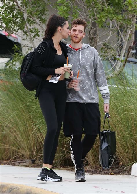 Adriana Lima packs on the PDA with boyfriend Metin Hara as they share a kiss on their way to the ...