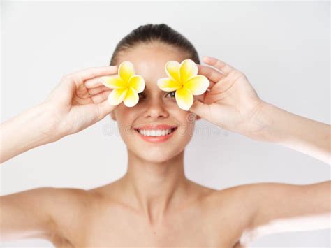 Cheerful Woman With Yellow Flowers Near Face Naked Shoulders Smile Background Stock Photo