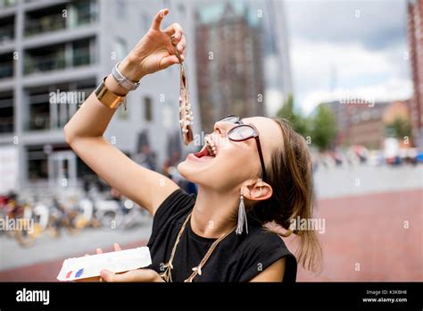 Woman with dutch herring Stock Photo - Alamy