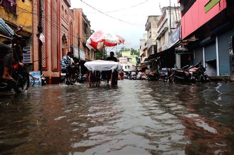 Meerut Commuters Wade Through A Waterlogged Road