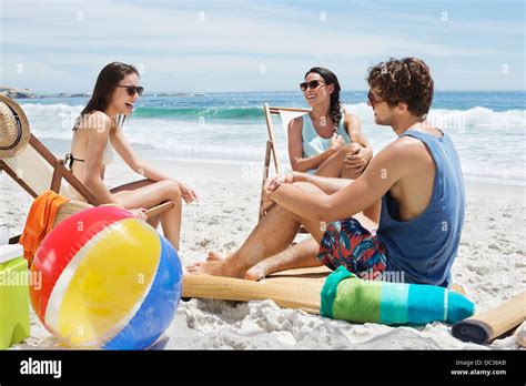 Friends hanging out at beach Stock Photo - Alamy