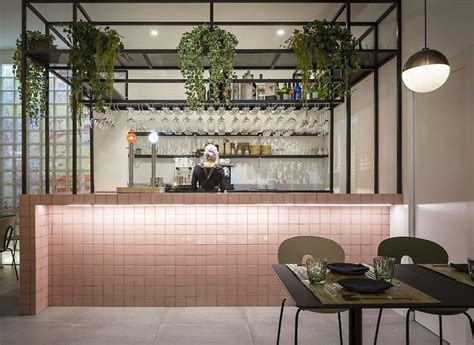 The Bar Is Decorated With Hanging Plants And Potted Plants On The Wall