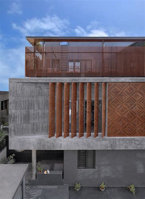 An Architecturally Designed Concrete Building With Wooden Balconies On