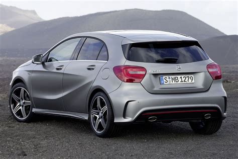 the rear end of a silver mercedes cla parked on top of a mountain range