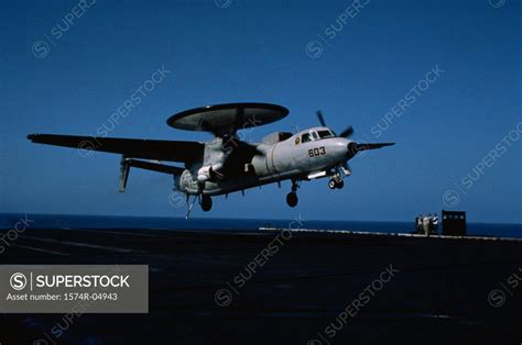 E-2C Hawkeye landing on an aircraft carrier - SuperStock