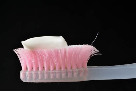 White toothpaste on a toothbrush. Black background 27720131 Stock Photo ...