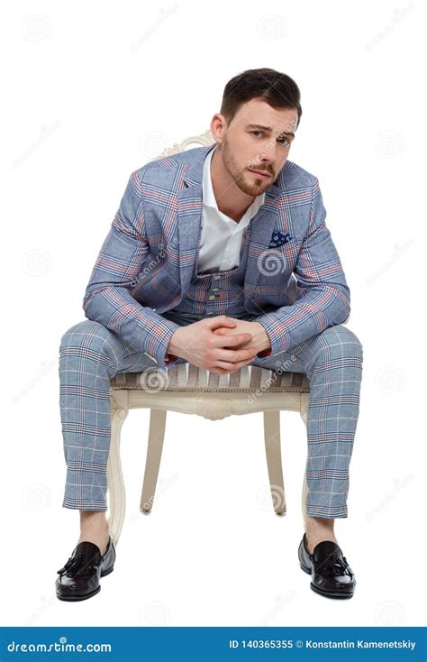 A Man In A Suit Is Sitting On An Expensive Chair Stock Image Image Of