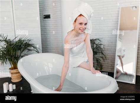 Morning Routine Of Redhead Beauty In The Bathroom Woman Running Bath Wants To Refresh In The