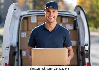 Smiling Delivery Man Standing Front His Stock Photo