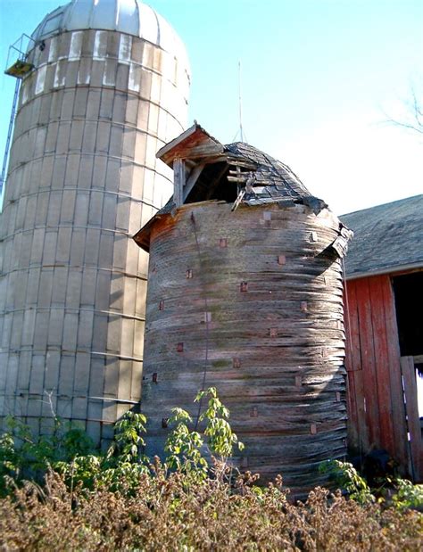 This Early Wooden Basket Weave Silo Stands Bravely Beside The Barn