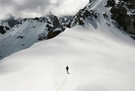 Free Download Hd Wallpaper Man Climbing Snow Covered Mountain