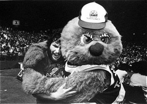 the mascot is wearing a hat and holding his arm around another mascot's ...