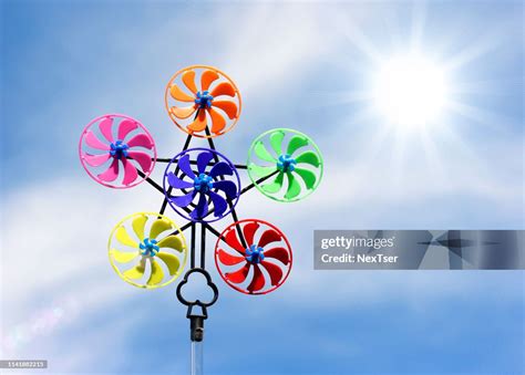 Low Angle View Of Colorful Pinwheel Toy Against Sky During Sunny Day