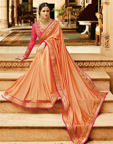 Hypnotic Peach Colored Partywear Designer Embroidered Silk Saree