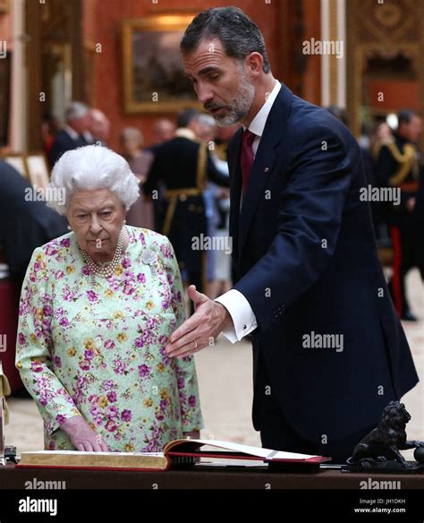 Queen Elizabeth II and Spain's King Felipe look at a display of Spanish ...