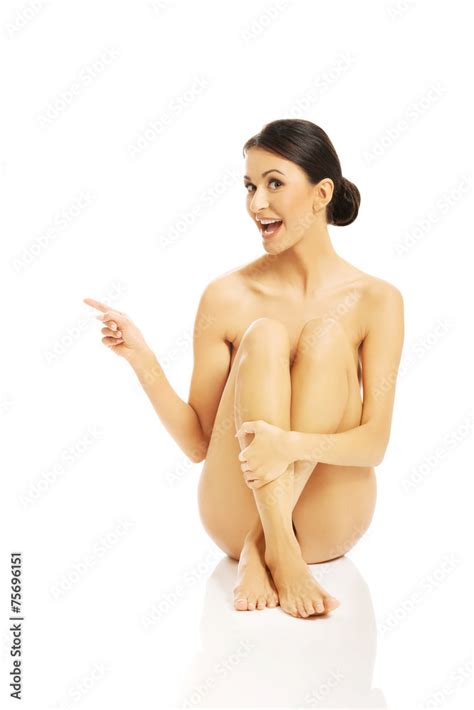 Nude Woman Sitting And Pointing To The Left Stock Photo Adobe Stock