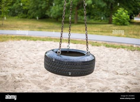 tire swing on playground in the park Stock Photo - Alamy