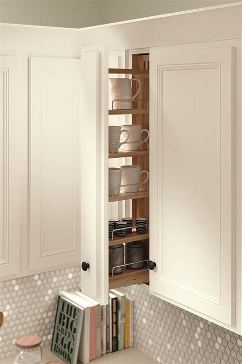 A Kitchen With White Cabinets And Shelves Filled With Dishes