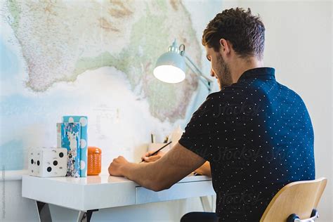 Handsome Man Sitting Behind A Desk By Stocksy Contributor Image