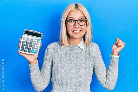 Beautiful Blonde Woman Showing Calculator Device Screaming Proud