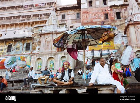 Varanasi, Uttar Pradesh, India : People sit at the ghats along the ...