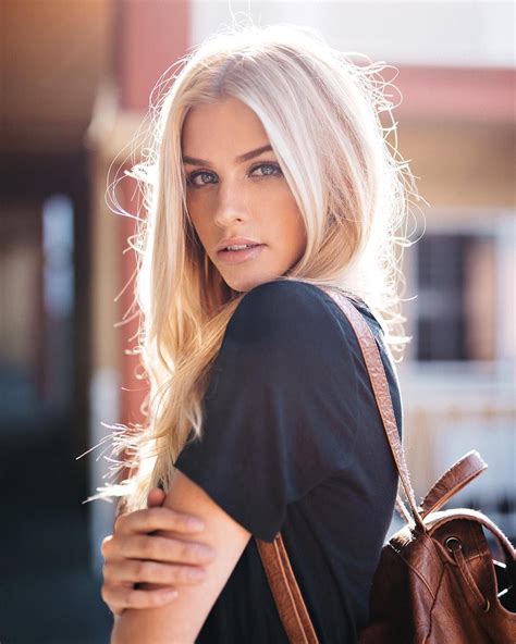 Black And White Photograph Of A Woman With Blonde Hair Carrying A Handbag On Her Shoulder
