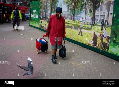 Elderly Woman Woman Struggles With Shopping Past A Regeneration Project