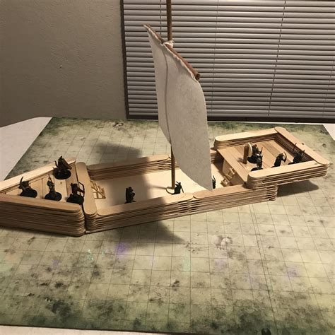 A ship made from popsicle sticks, matches, floss, and paper towel