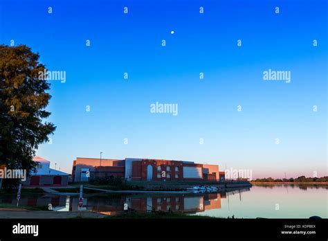 Bachman Lake Rowing Boathouse At Sunrise With Calm Water And Moon Stock