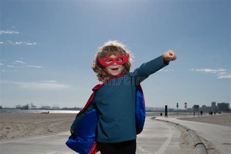 Kid Having Fun Outdoors In Super Man Cloak Boy Playing Superhero