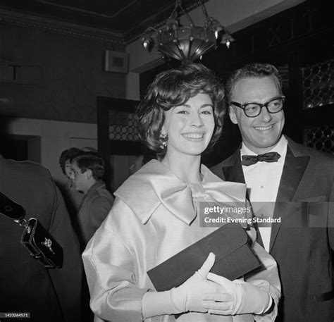 British Actress Nanette Newman Wearing A Satin Outfit With A Large