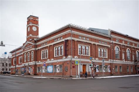 Premium Photo A Red Brick Building With A Clock On The Front And A