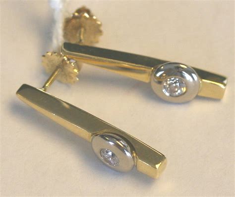 A Pair Of Diamond Set Single Stone Earrings In An Abstract Modern