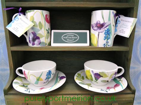 Two Cups And Saucers Are Sitting On A Shelf Next To Each Other With Tags