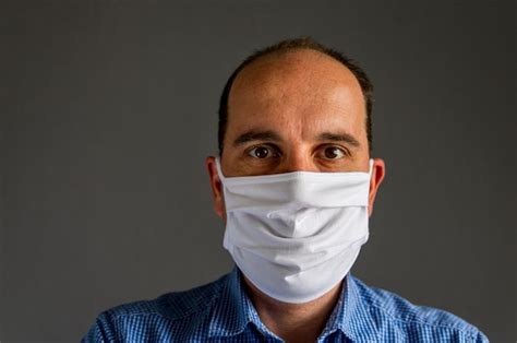 Premium Photo Portrait Of Man Wearing Mask Against Black Background