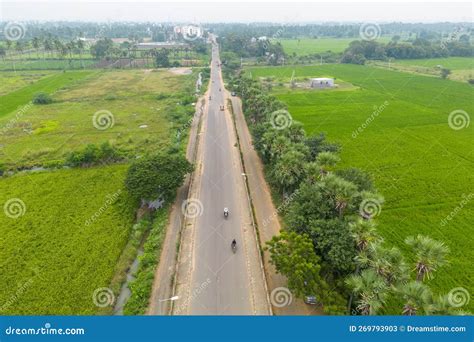 Aerial View Of Rural Road Passing Through Paddy Fields In Guntur