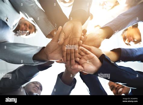 Teamwork On Three Low Angle Shot Of A Diverse Group Of Businesspeople