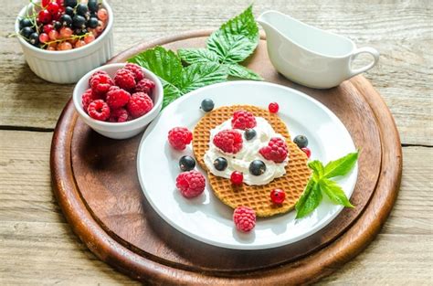 Premium Photo Belgian Waffles With Whipped Cream And Fresh Berries