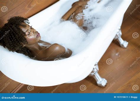 Beautiful African American Woman Bathing In A Tub Full Of Foam Stock