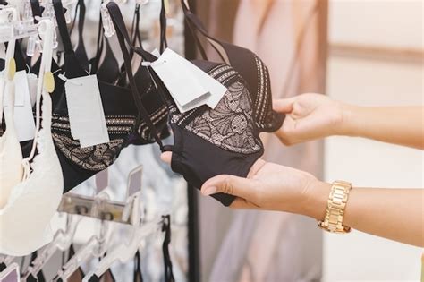 Premium Photo Women S Hands Are Holding A Lingerie At Shop Woman Underwear Clothes In The