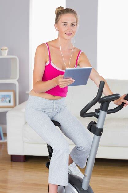 Premium Photo Sporty Smiling Blonde Training On Exercise Bike Using