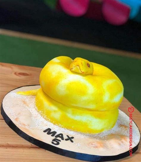 There Is A Yellow Cake With A Snake On It