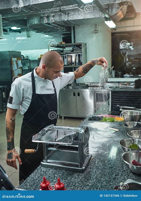 Cooking Process Side View Of Handsome Young Chef With Black Tattoos On