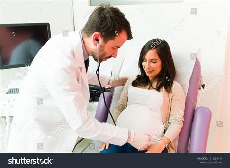 Male Gynecologist Using Stethoscope Belly Smiling ภาพสต็อก แก้ไข