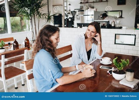 Happy Female Friends Chatting In Cafe Two Beautiful Young Women